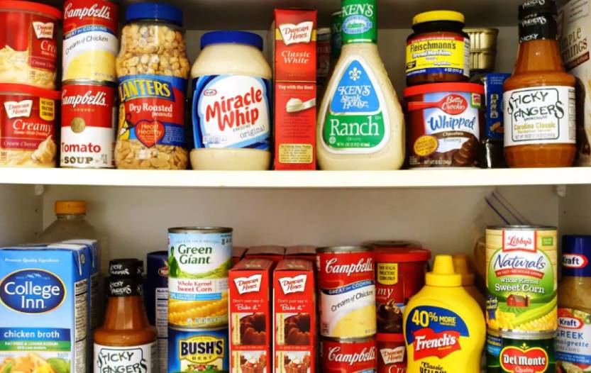 Two-week emergency food supply arranged on pantry shelves