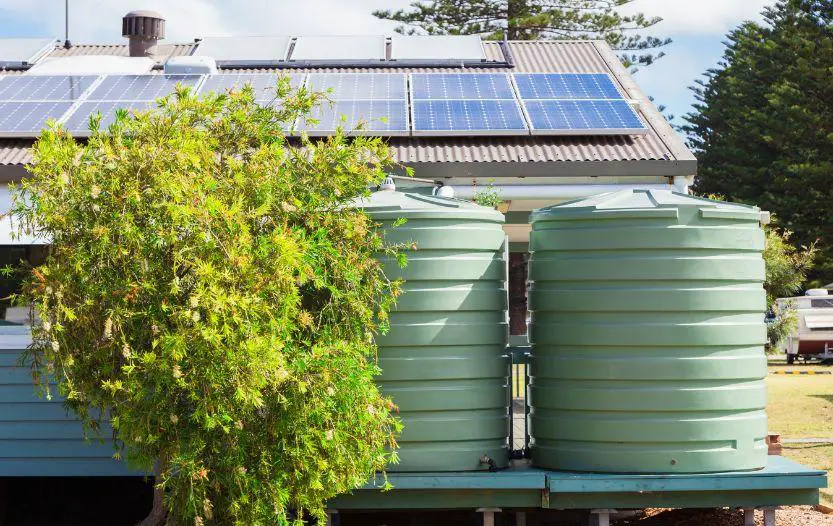 Rainwater storage tanks beside a solar-powered home