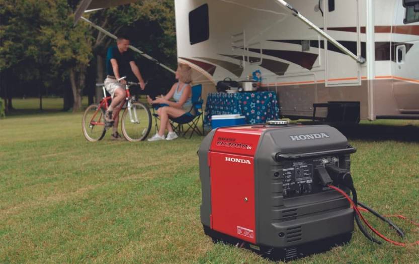 Portable generator operating outdoors beside a recreational vehicle