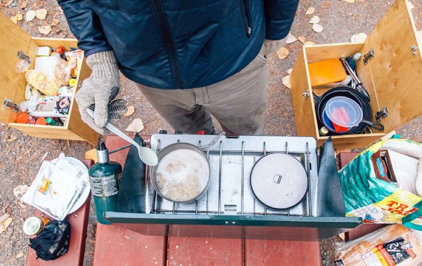 Cooking with emergency food supplies at an outdoor camp