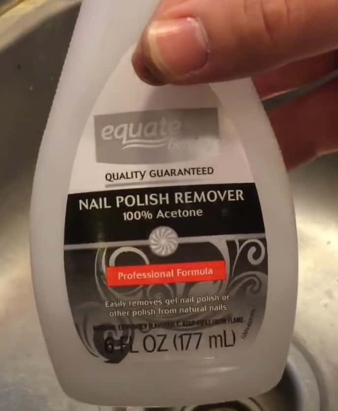 Bottle labeled acetone nail polish remover