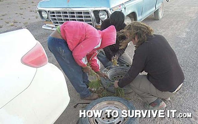 People placing vegetation around a damaged car wheel