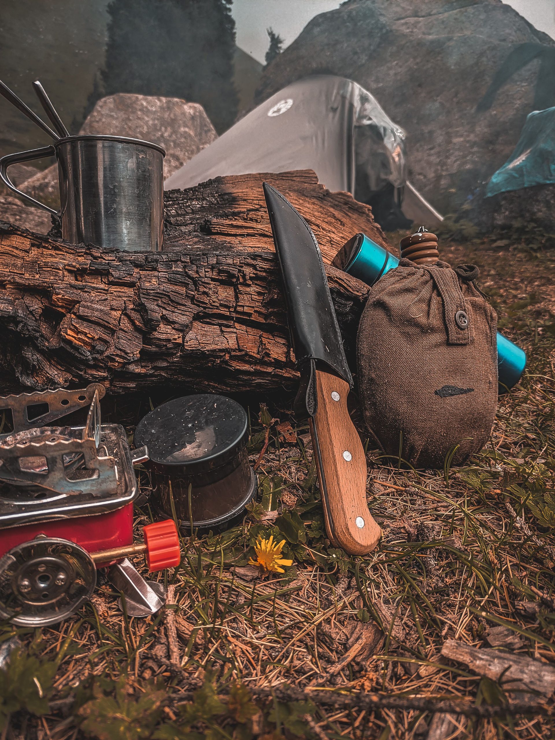 Camping tools arranged beside a tent for outdoor field testing