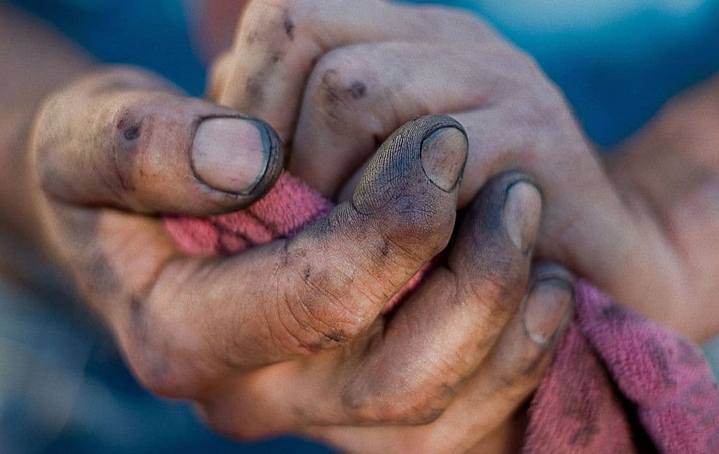 Close view of dirty hands being cleaned