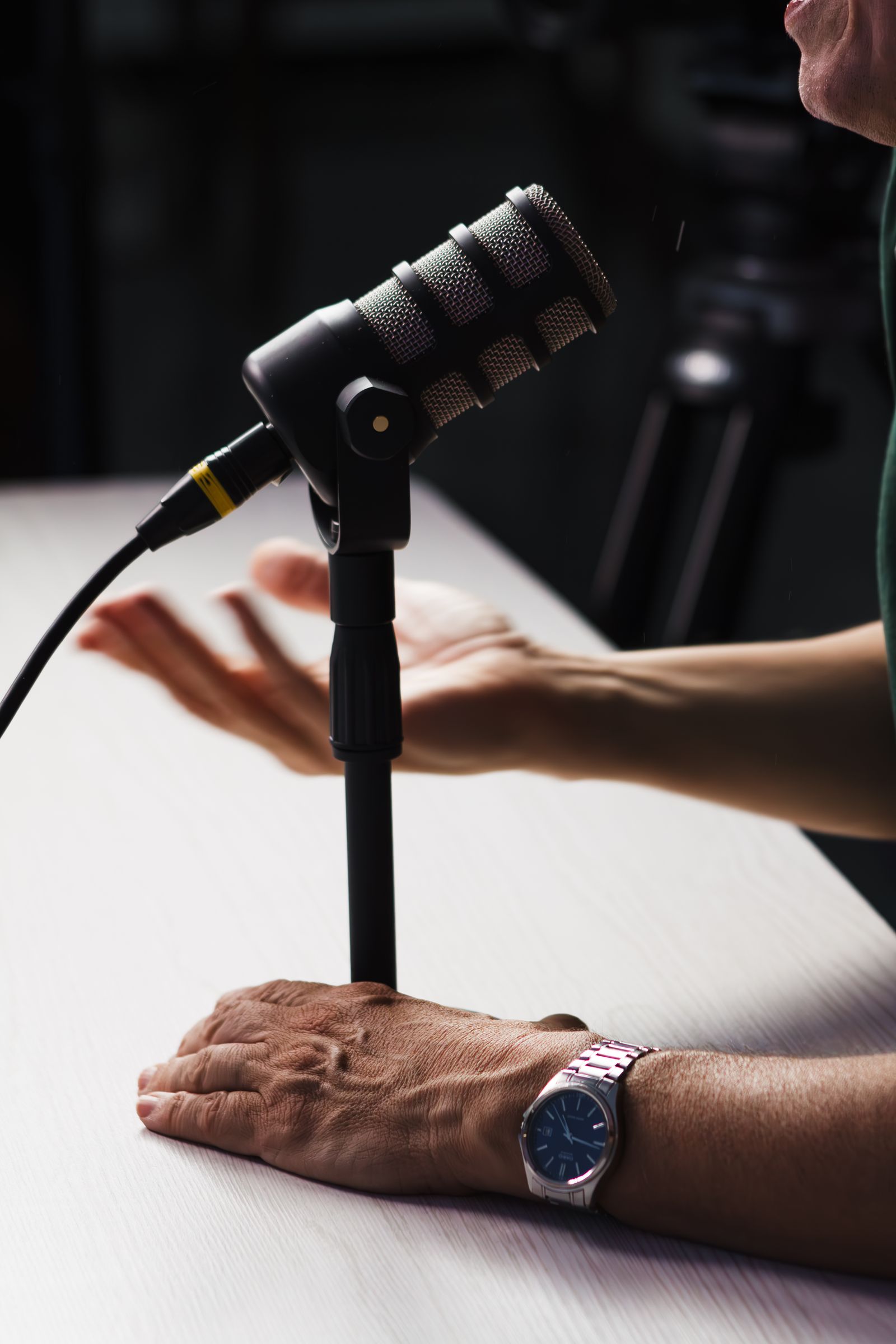 Microphone and speakers recording a conversation in a podcast studio