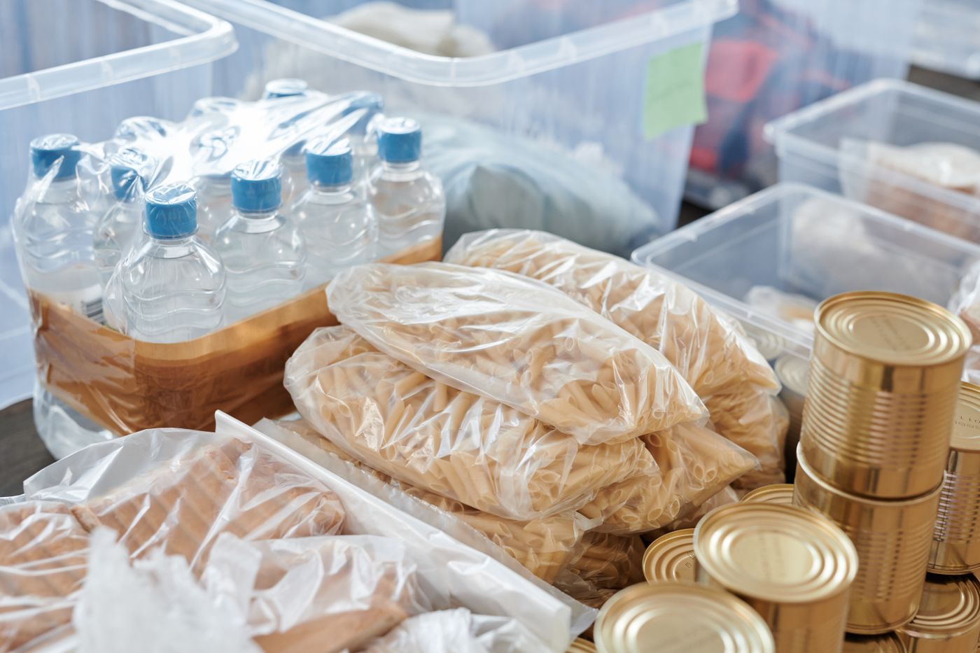 Emergency food, bottled water, and supplies organized for storage