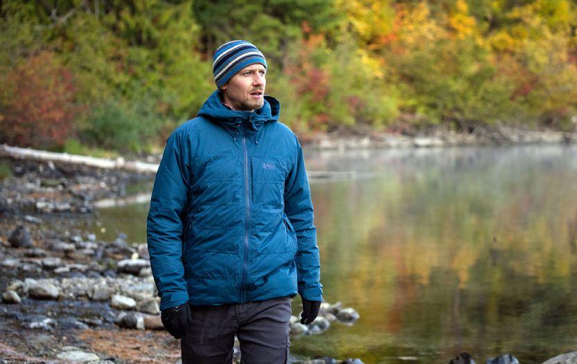 Guy by the lake wearing REI Co op Stormhenge Down Hybrid