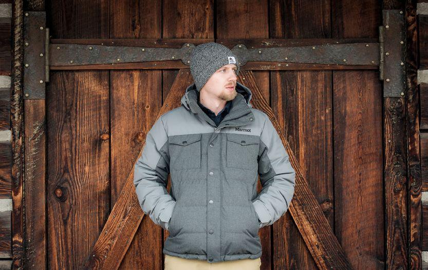 Guy leaning on a barn door wearing Marmot Fordham Jacket